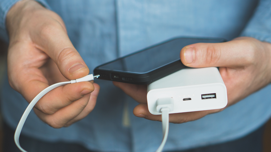 man charging phone battery